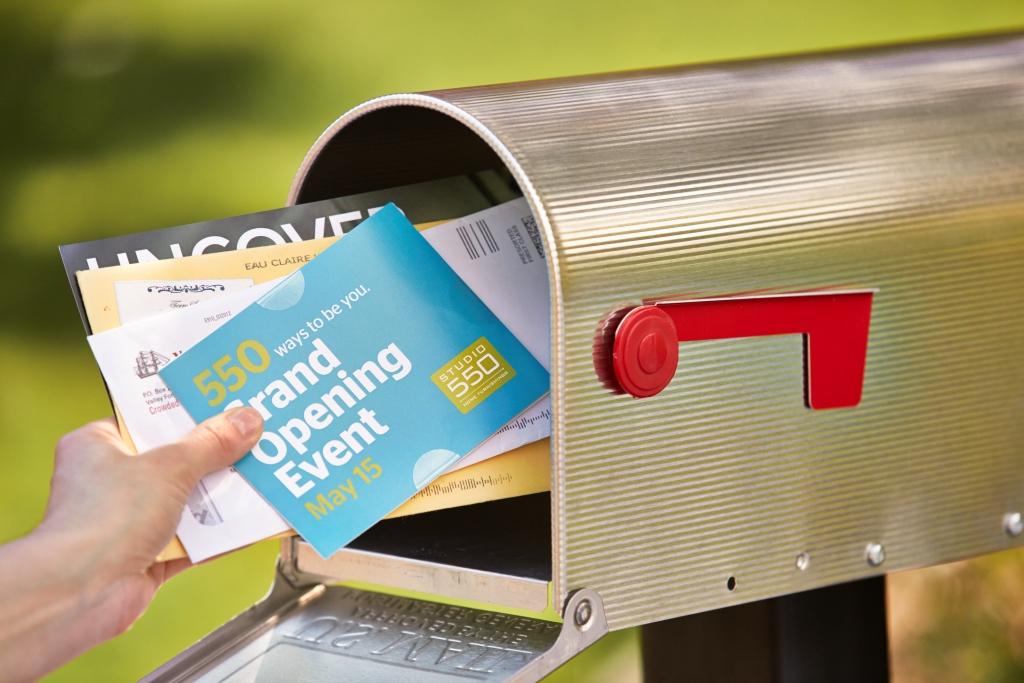 Close-up of a mail box, with colorful direct mail postcard, vibrant design, engaging graphics, Omaha marketing
